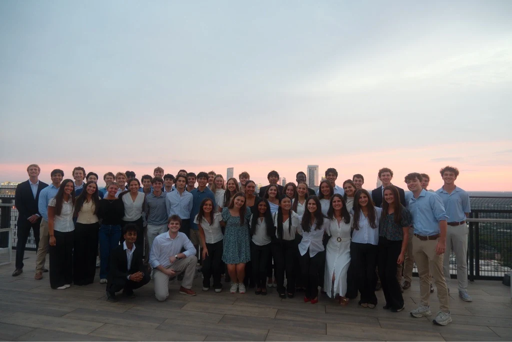 Engineers in Business members gathered on a rooftop at sunset in Austin